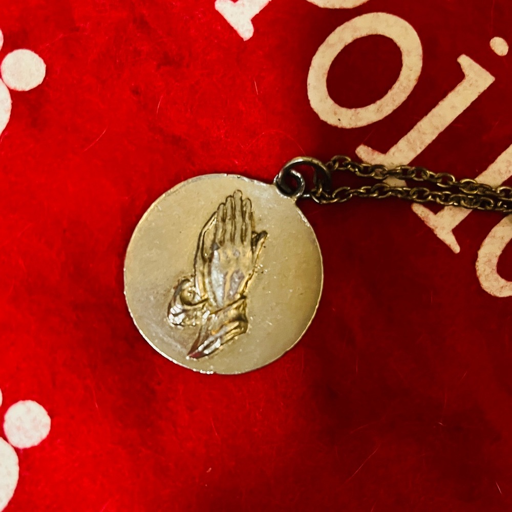 Praying hands charm, silver coloured not sure of material.